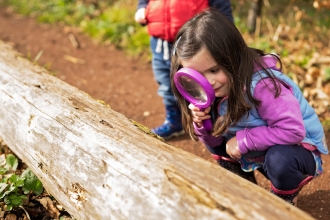 Girl with magnifying glass
