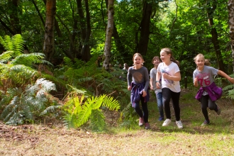 Children running in woods