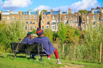Two people sitting on a park bench