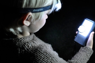 A child holds a Bat monitoring device