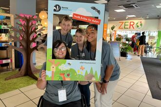 Group of young people smiling through a photo frame 