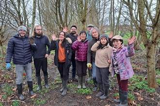 Group of people in woodlands in the winter. 