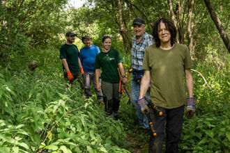 Volunteers walking down a path at Papercourt Marshes