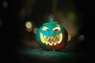 an illuminated carved pumpkin