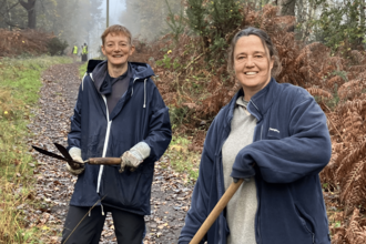 Two Normandy Conservation Volunteers opening a ride and smiling for the camera 