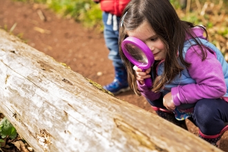 Girl with magnifying glass