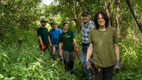 Volunteers walking down a path at Papercourt Marshes
