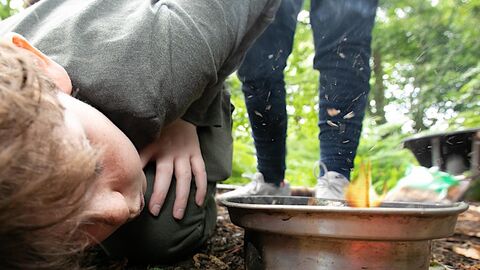 children learning to light fire at holiday club
