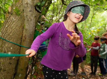 Girl blindfold trail woods