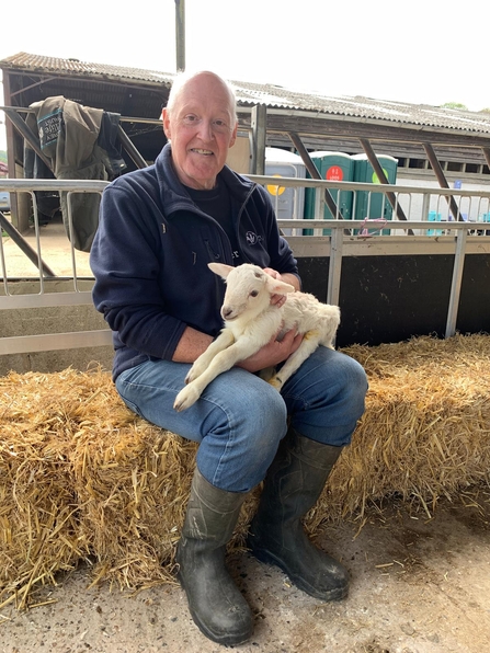 One of our volunteer ambassadors holding a lamb during our 'Meet the Newborns' event at Bonhurst Farm
