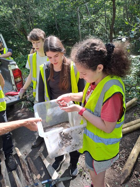 Student holding a grass snake