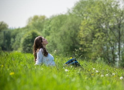 Woman relaxing in field