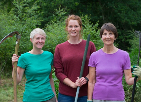 Volunteers with scythes