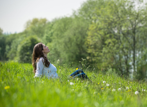 Woman relaxing in field