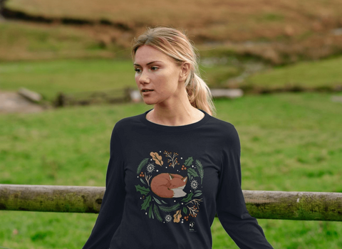 Woman wearing an illustrated fox Christmas jumper