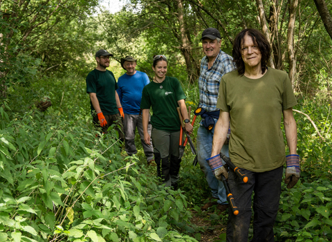 Volunteers walking down a path at Papercourt Marshes
