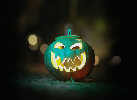 an illuminated carved pumpkin